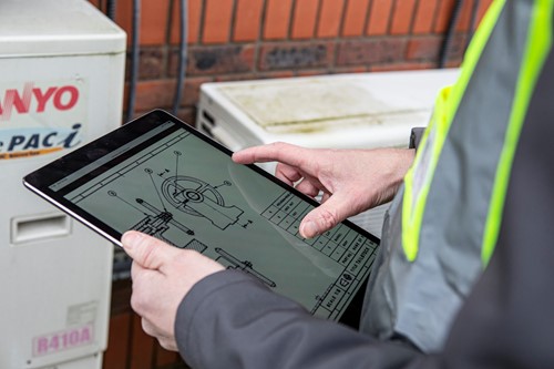 An estate manager using a tablet during a site visit
